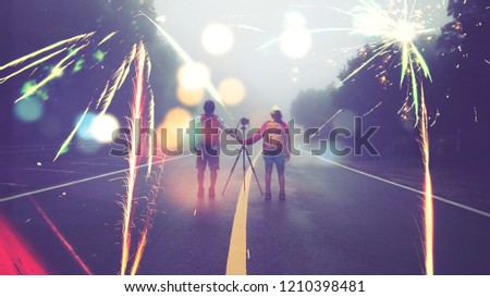 Travel nature Lover asian women and asian man Take a picture Shoot the fireworks In New Year's Mountain. Thailand