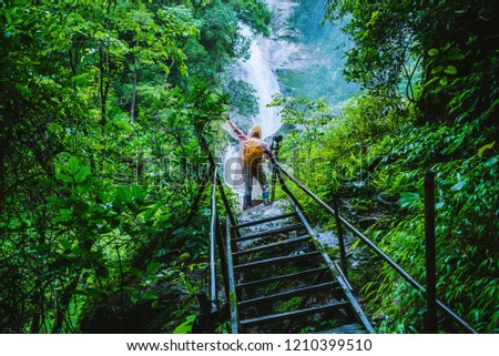 Asian women travel Take a picture Nature Study. Travel the highest waterfall in Chiangmai Mae-pan rainy season at Doi intanon in Thailand.