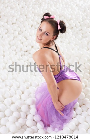 Woman posing in white balls background