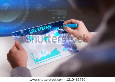 Business, Technology, Internet and network concept. Young businessman working on a virtual screen of the future and sees the inscription: Live stream