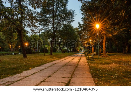 Carol Park - Bucharest, Romania.
Wooden bench and on an empty alley.