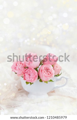 fresh pink roses on white background. cute bouquet of roses in Cup.   celebration concept Valentine's day, Mothers Day. beautiful scene of love and tenderness, greeting background