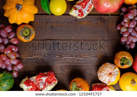 Frame of fruits on a wooden background. Autumn harvest. Top view, copy space