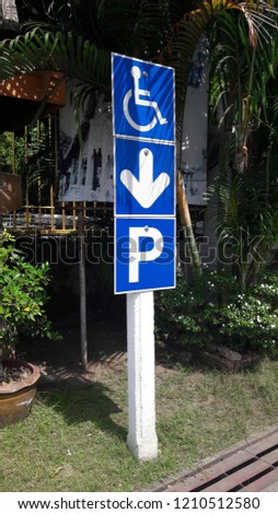 Car parking sign for disabled people at the roadside in Thailand