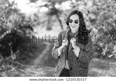 Pretty long hair bruntte girl walking in the autumn forest