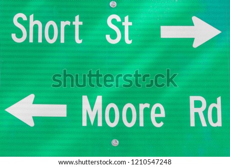 A street sign that says Moore road and short street.