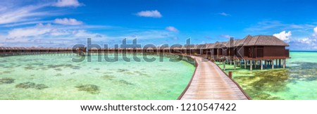 Panorama of Water Villas (Bungalows) at Tropical beach in the Maldives at summer day
