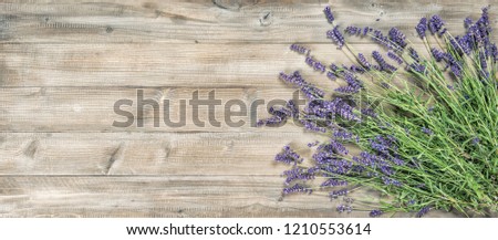 Lavender flowers on rustic wooden background. Vintage style picture