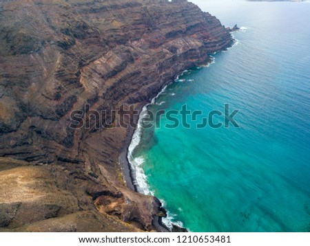 Aerial view of the mountainous coasts of the island of Lanzarote, Canary Islands, Spain. Africa. Reliefs overlooking the sea and dirt paths. Hiking trails