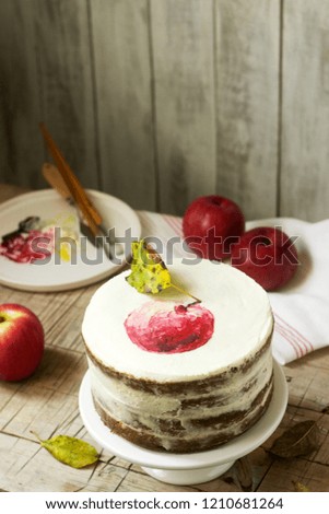 Apple cake with curd cream, decorated with painted apple on the background of autumn composition. Rustic style.