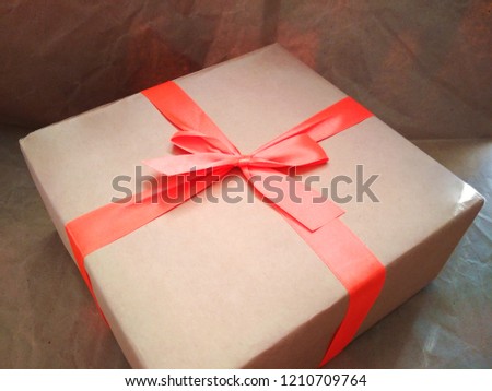 Craft cardboard paper box orange ribbon bow gift surprise present photo