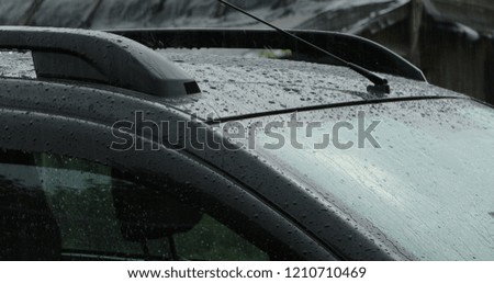 car roof and windshield with water drops after rain