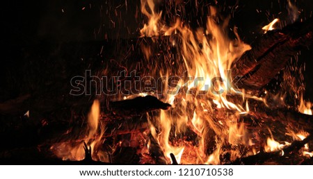 bright flaming of fire and hot wood at night