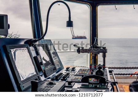 Bridge ship equipment of ffshore dp vessel thruster pitch propellers telegraph handles vhf radio, navigation devices Royalty-Free Stock Photo #1210712077