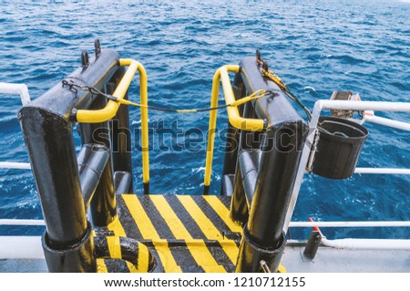 View of offshore vessel boatlanding - installation for crew change. Safe work at sea Royalty-Free Stock Photo #1210712155