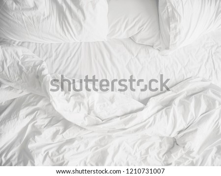 Top view of unmade bedding sheets and pillow ,Unmade messy bed after comfortable sleep concept Royalty-Free Stock Photo #1210731007