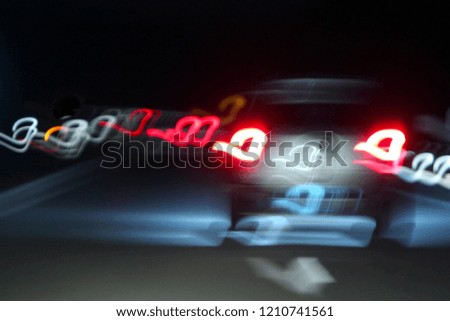 Abstract. Grain. Blurred. Slow shutter speed with reflection light divider at highway on night time