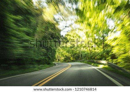 A long exposure shot of a road  from inside a car