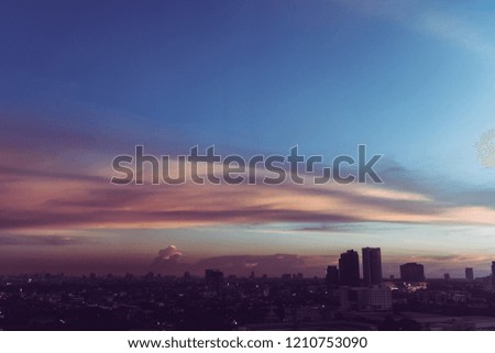 Colorful cloud and sky sunset over cityscape.