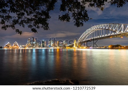 Sydney City, Australia. Night cityscape looking over Sydney Harbour including the famous Opera House and iconic Sydney Harbour Bridge.