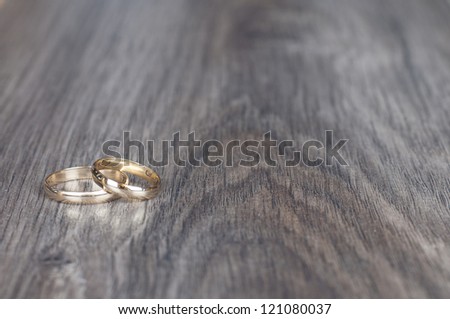 wedding rings on wooden table