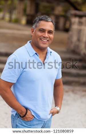 Handsome middle age Hispanic man in casual clothing outdoors. Royalty-Free Stock Photo #121080859