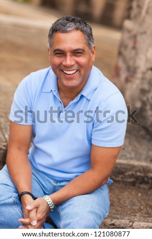 Handsome middle age Hispanic man in casual clothing outdoors. Royalty-Free Stock Photo #121080877