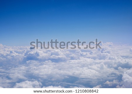 Plane wing on the sky with cloud, view from airplane window.