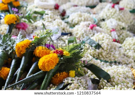 Closeup of colorful marigold and jasmine flowers used for giving respectation in asian traditional spiritual ceremony.