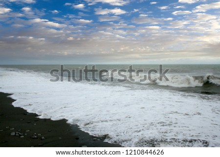 beautiful beach and sea waves in the rays of the sunset sunny sky