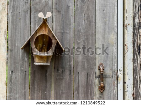 wood mailbox on wooden fence door background.