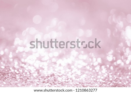 Rose gold glitter confetti defocused background texture.