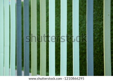 Multi-colored metal fence. Perspective. Metal fencing. Iron fence. Parallel straight.