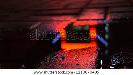 Background of wet asphalt with neon light. Blurred background, night lights of a big city, reflection, puddles. Dark neon bokeh.