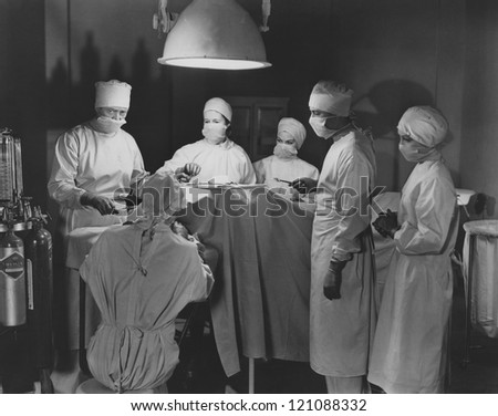 Team of surgeons perform operation Royalty-Free Stock Photo #121088332
