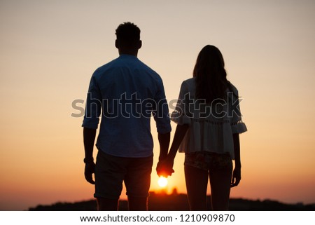 Silhouette of a beautiful romantic couple at sunset