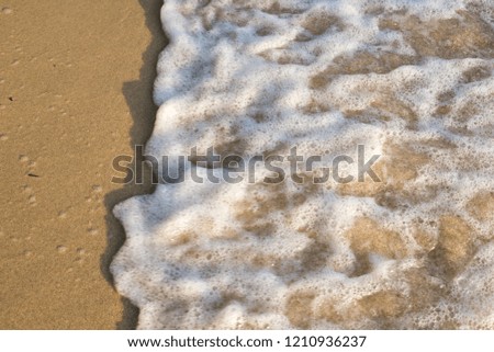 Abstract of Sand and soft waves at the Beach. soft focus due to water movement.