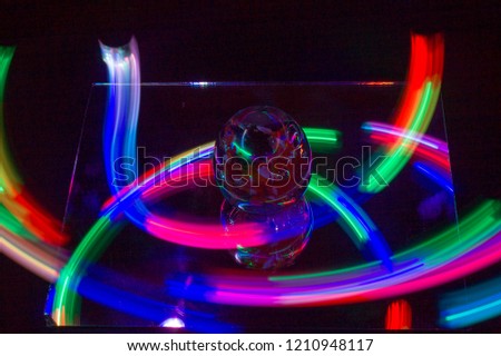 Colorful Light Painting Photography With Cristal Ball Against A Black Background