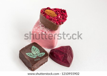 Hand made chocolate sweets on white background. Mint, heart shape beautiful delicious dessert.