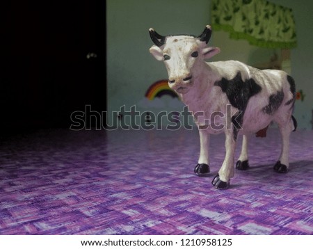 Rubber cow toy for children on the table.