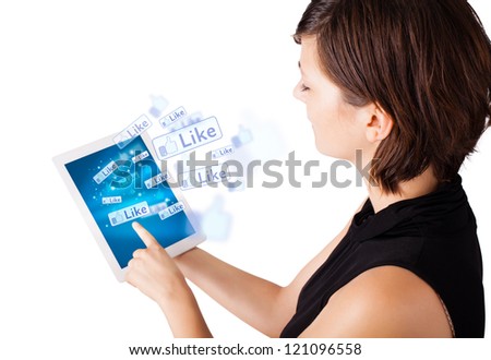 Young business woman looking at modern tablet with social icons