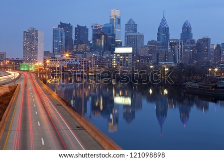 City of Philadelphia. Image of Philadelphia skyline, Schuylkill River and busy highway leading in to the city during sunset.