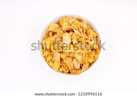 Breakfast cereal - sugar-coated flakes of corn 
 Royalty-Free Stock Photo #1210996516