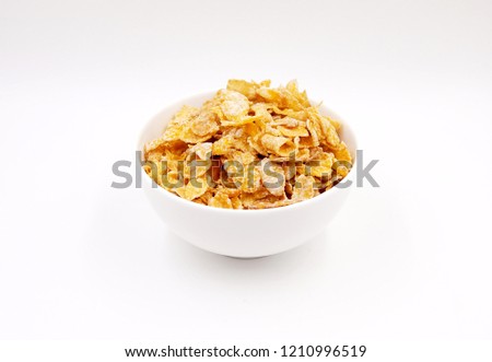 Breakfast cereal - sugar-coated flakes of corn 
 Royalty-Free Stock Photo #1210996519