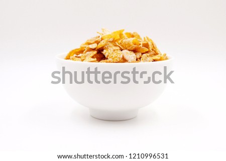 Breakfast cereal - sugar-coated flakes of corn 
 Royalty-Free Stock Photo #1210996531