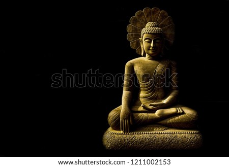 Statue of Buddha sitting in meditation
With black space on the right hand side