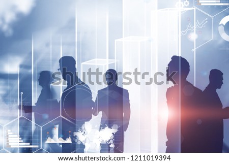 Silhouettes of business people over blue sky background with big bar chart and infographics foreground. Toned image double exposure Elements of this image furnished by NASA
