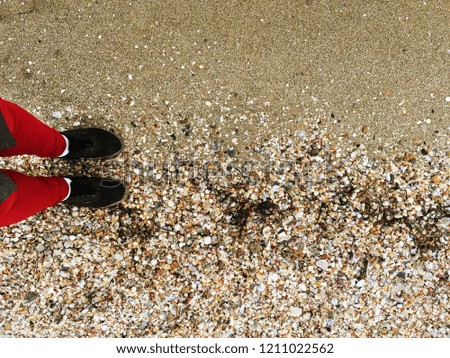 foots standing on the sand beach. Ready to travel!