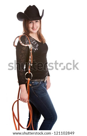 Attractive young woman carrying a horses bridle.  Isolated on white.