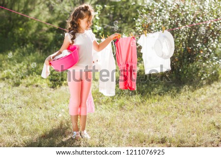 Cute little girl laundring
